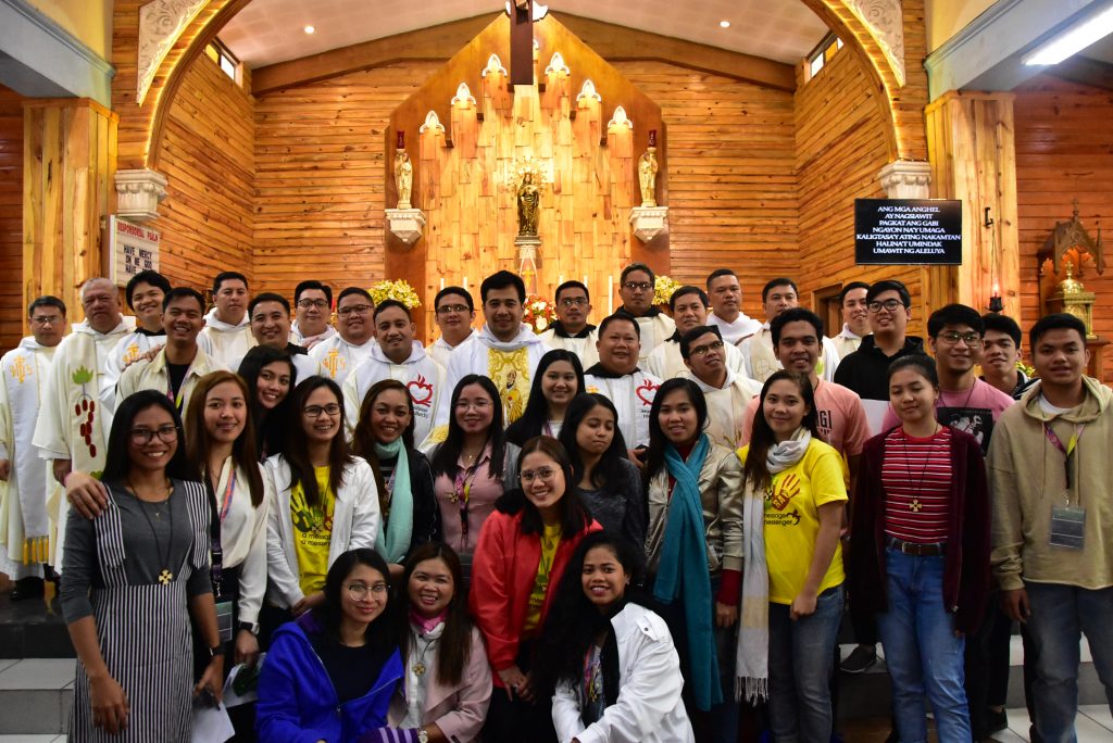 The first set of national officers of RAY, led by the president Roceline Bernal (standing, sixth from left), poses for a photo opportunity </br> with the Recollect religious after having been sworn into office.