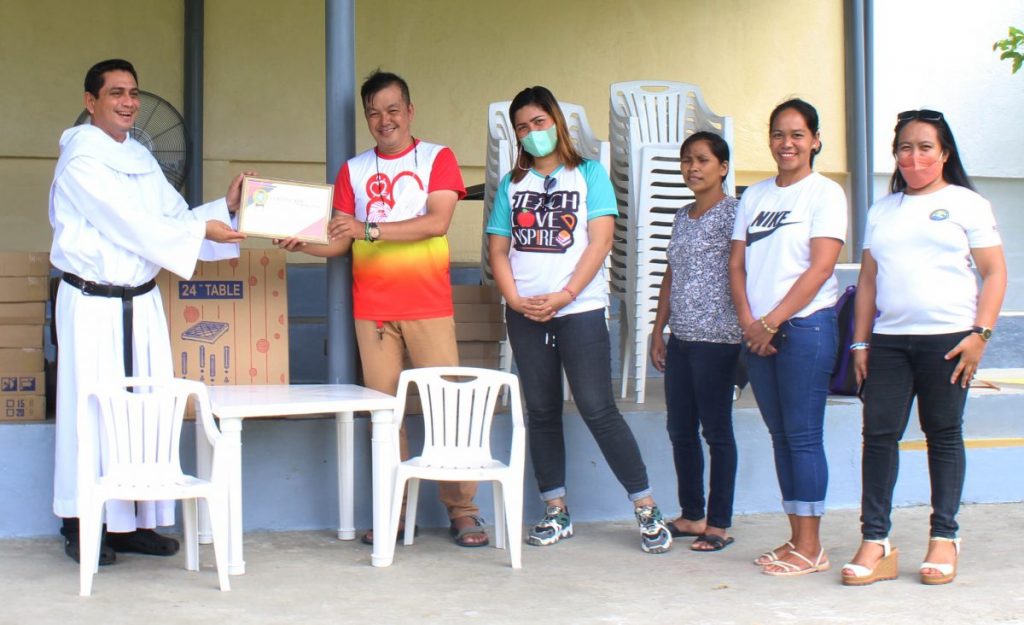 Continued Partnership. Rev. Fr. Vicente Ramon, Jr., OAR, director of CST-R Community Extension & Development Office, accepts the Certificate of Appreciation from Ansulag ES.             