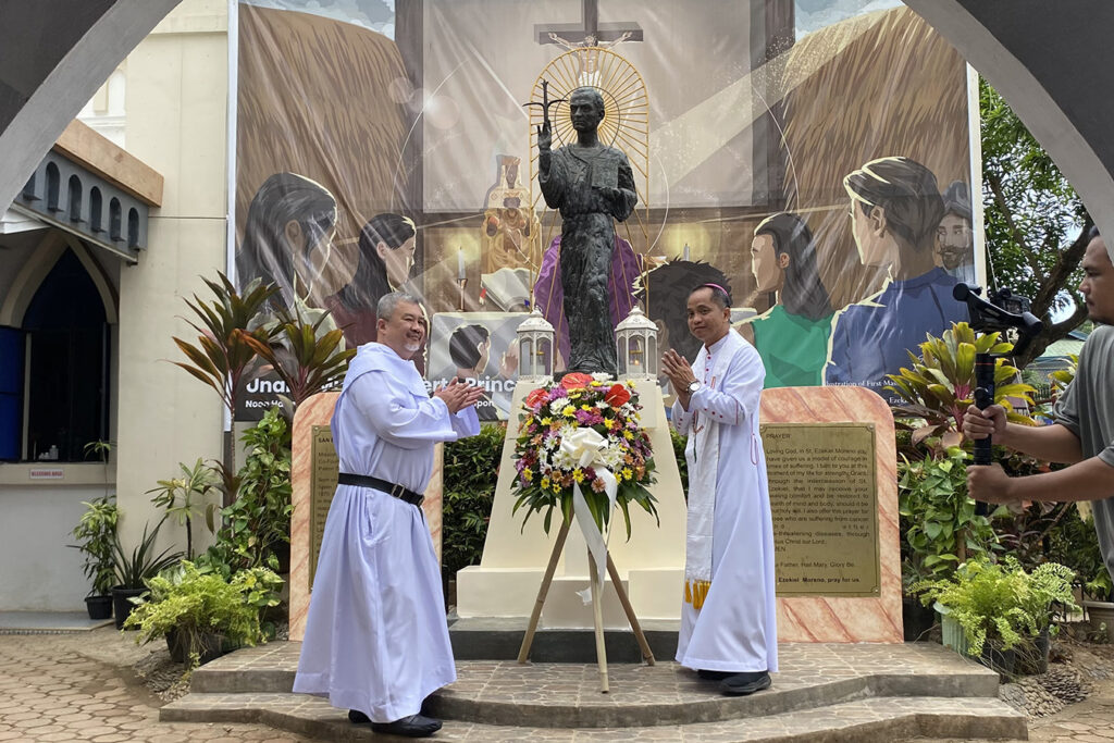 Bishop Socrates Mesiona of Puerto Princesa and Fr. Bernard Amparado, Prior Provincial of the Province of St. Ezekiel Moreno, offer flowers at the statue of St. Ezekiel Moreno outside the Immaculate Conception Cathedral in Puerto Princesa City on March 4, 2023. 